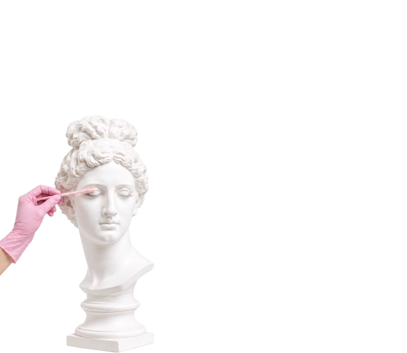 Classical statue having its lashes lifted with a pink brush